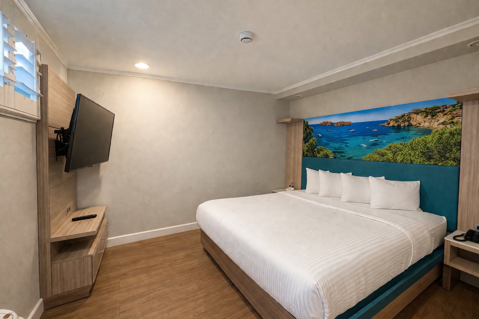 Deluxe King Jacuzzi Suite king bedroom with shuttered window